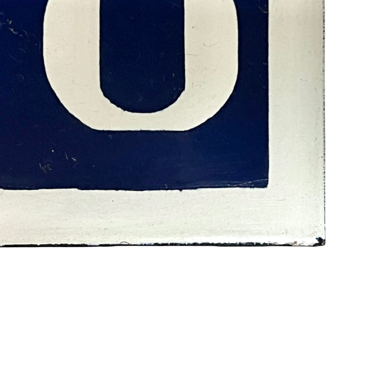 Close-up of a blue sign with white number 118 on a white background