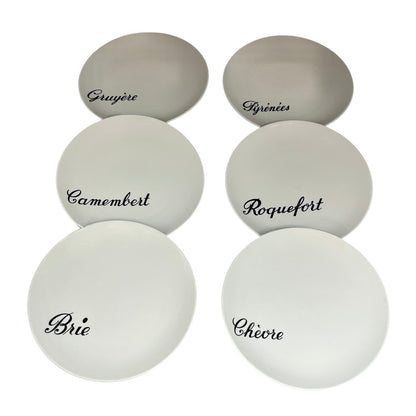 Set of white cheese plates with black text on a white background