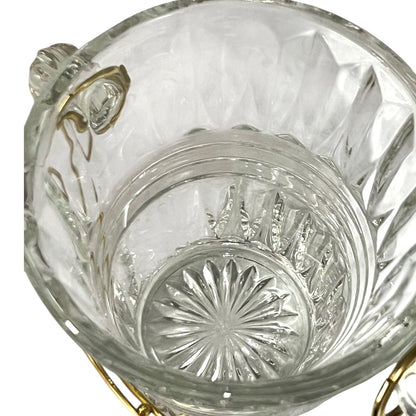 Clear glass candy dish with gold accents on a white background