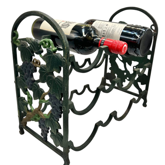 Decorative metal wine rack with a bottle of red wine on a white background
