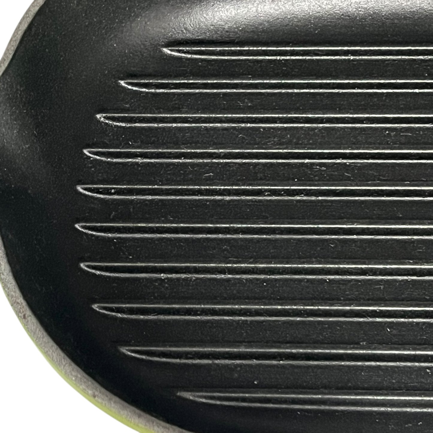 Close-up of a black cast iron skillet with ribbed surface