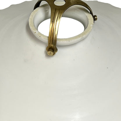 Close-up of a ceiling light fixture with brass fitting on a white background