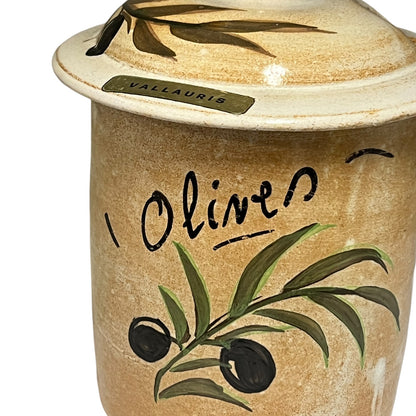 A ceramic olive jar with a matching lid, featuring a hand-painted olive branch design and the word 'Olive' written on the front, with a small 'VALLAURIS' label on the lid.