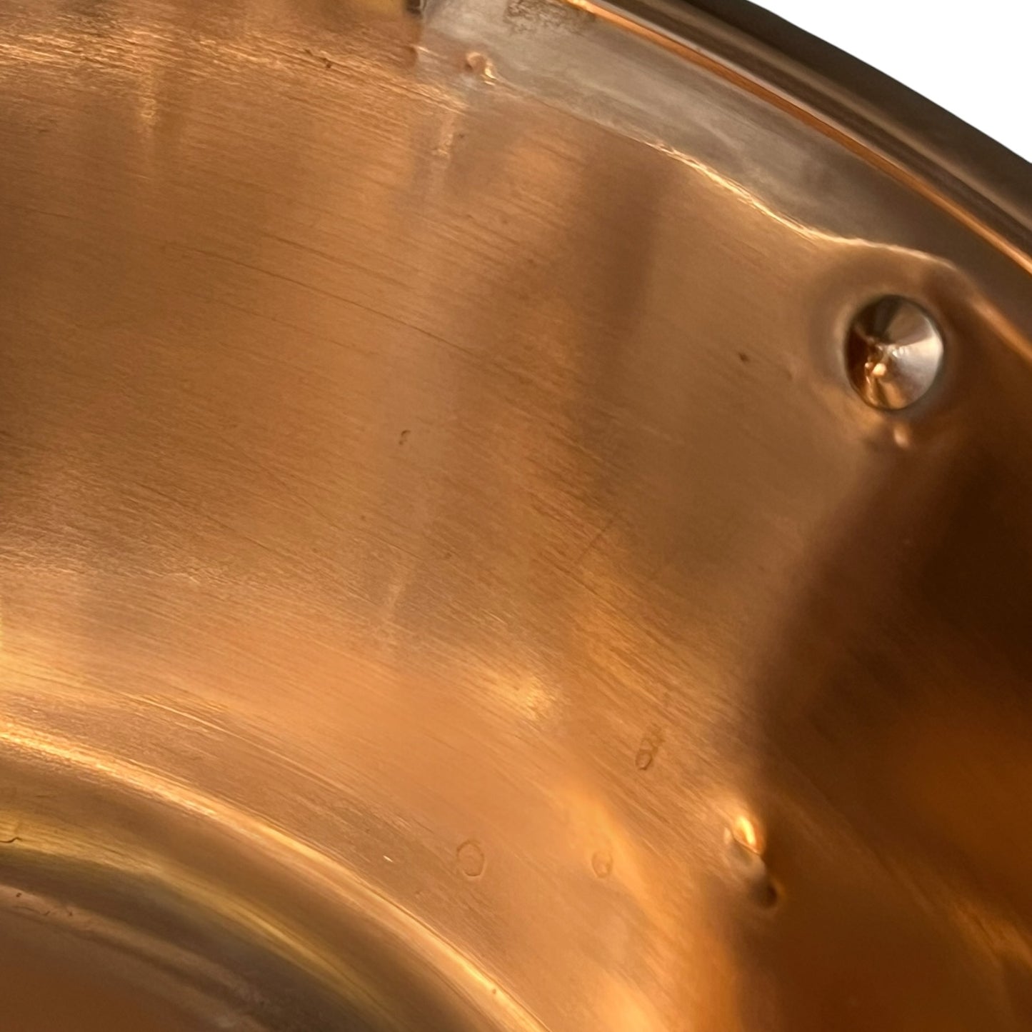 Close up of a French copper bathroom basin on a white background
