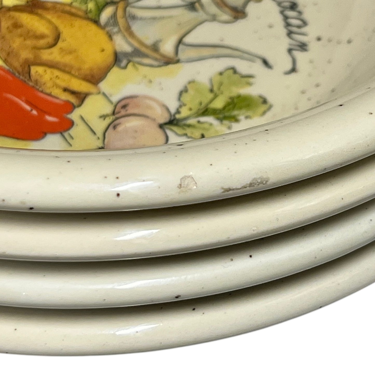 Stack of ceramic plates with colorful illustrations on a white background
