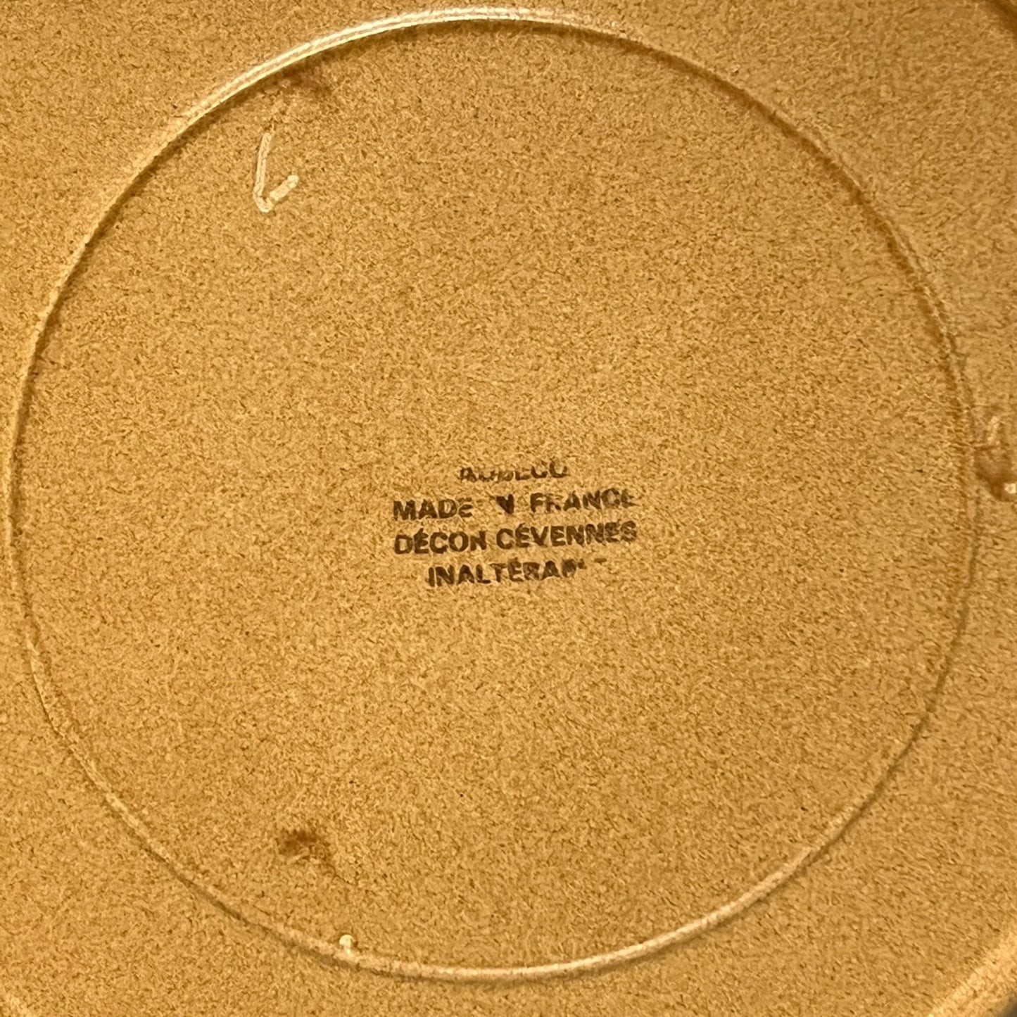 Close-up of a plate with a clear makers stamp in black text