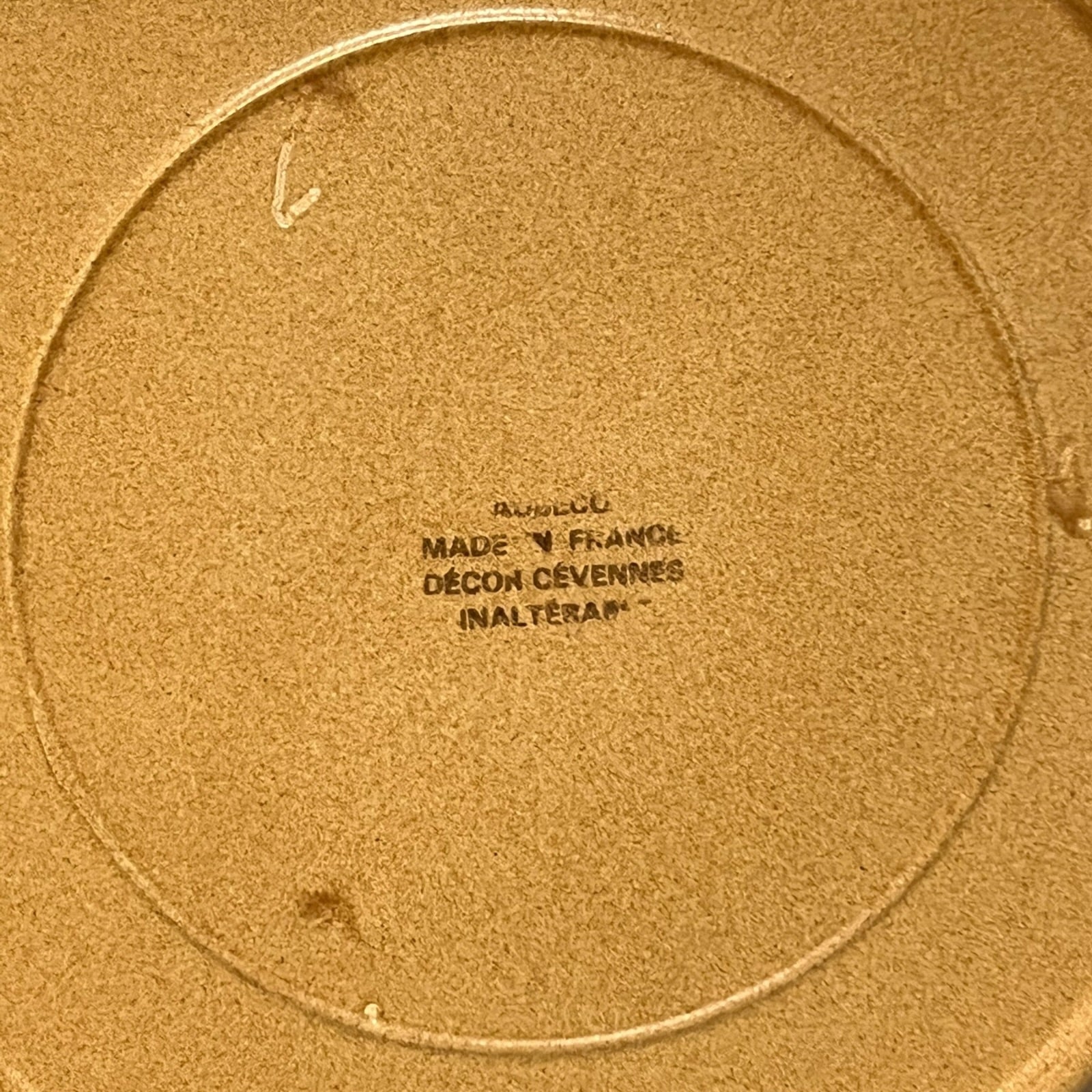 Close-up of a plate with a clear makers stamp in black text