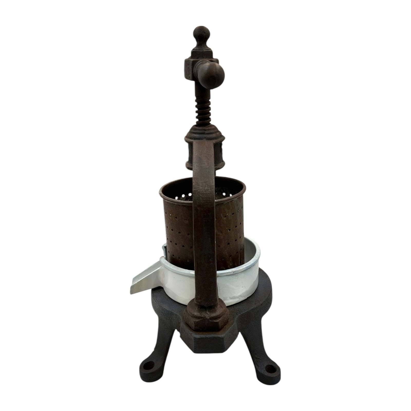 Vintage French cast iron metal fruit press with a white enamel container on a white background