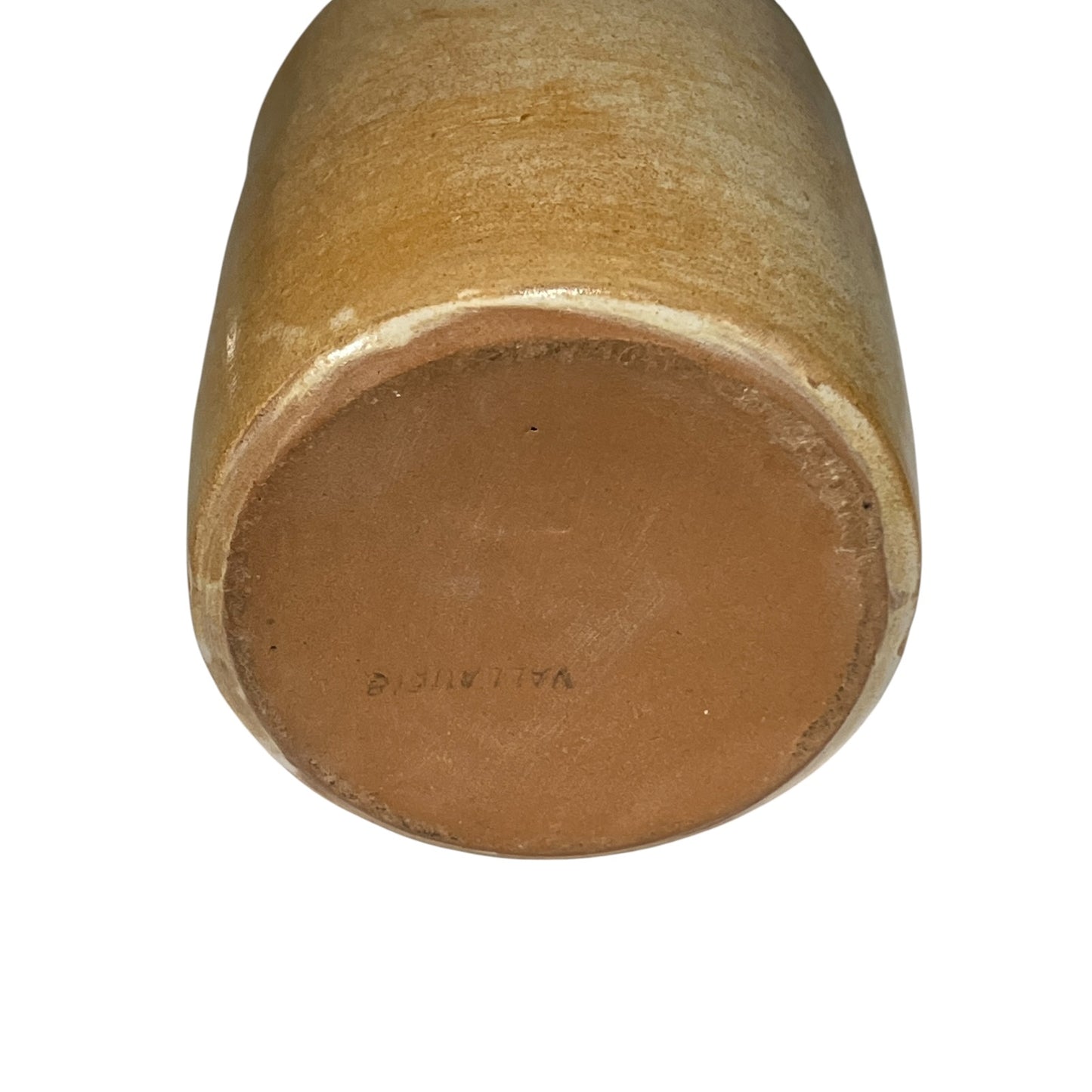 Close-up of the round bottom of a ceramic vase or planter, showing a smooth glazed finish in warm tan and brown tones against a plain white background.