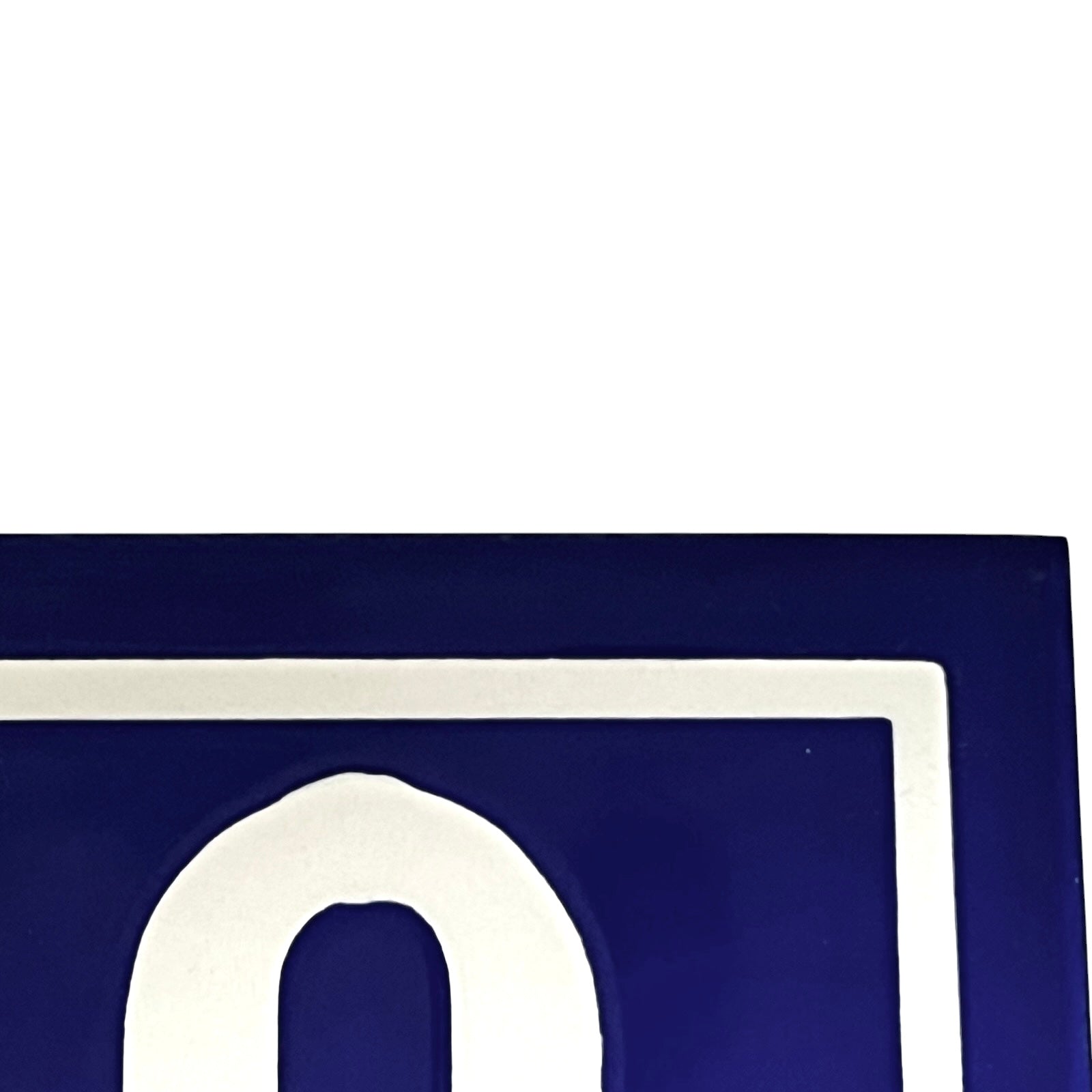 Close up of a French blue and white door number on a white background 