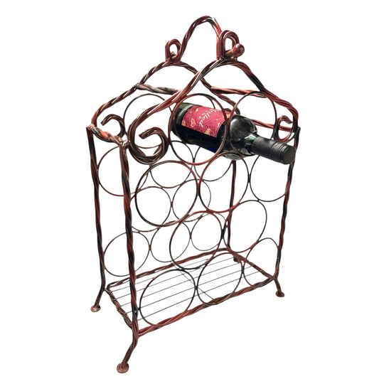 Vintage French red enamel wine bottle rack holding one bottle on a white background