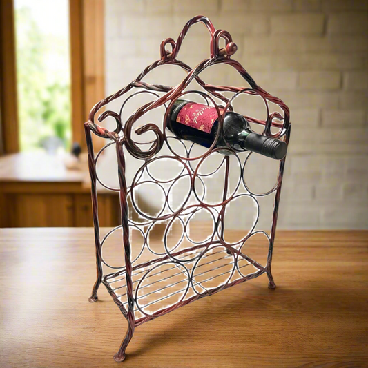 Wrought iron wine rack with a bottle of red wine on a wooden table.