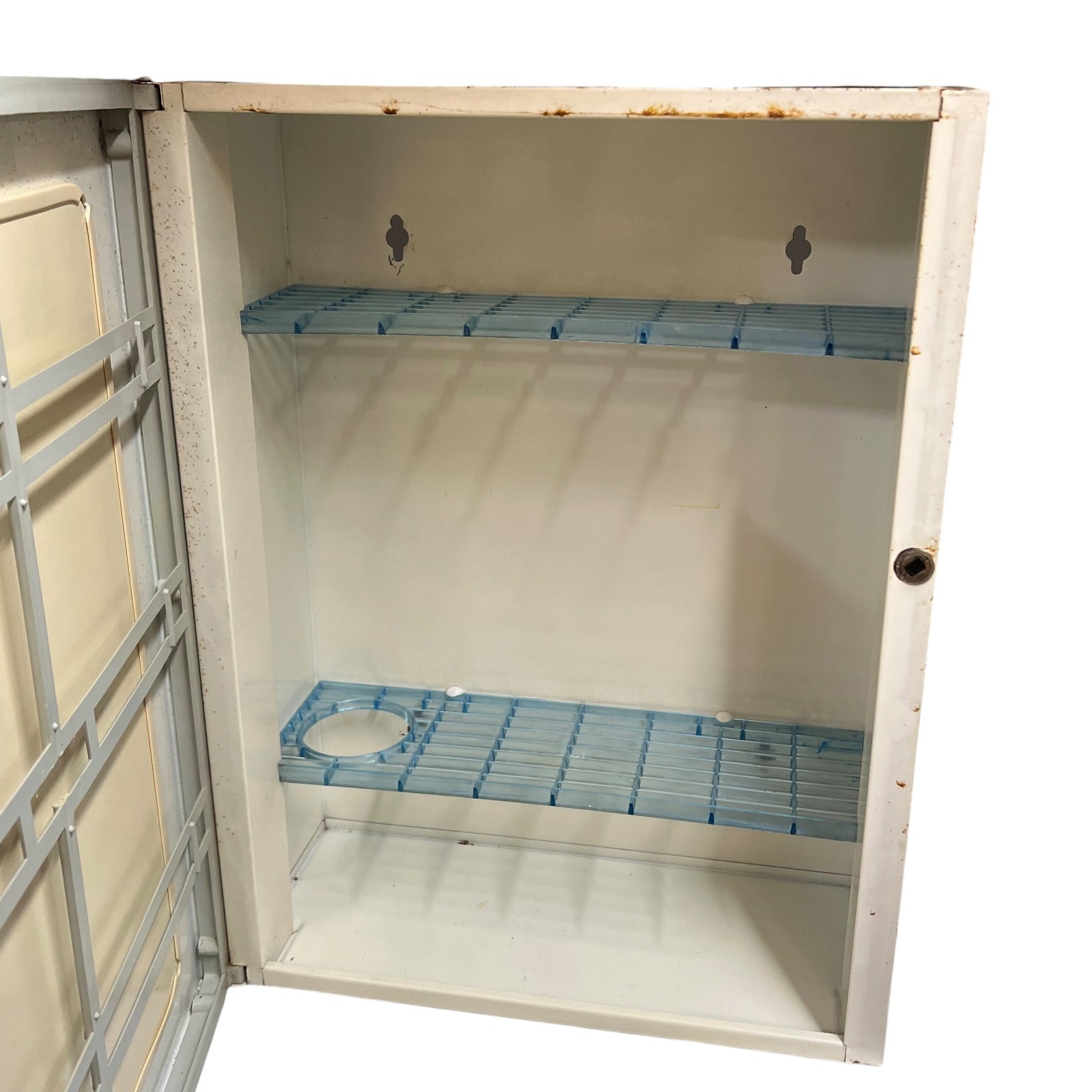 close up of a vintage metal bathroom cabinet inside view on a white background