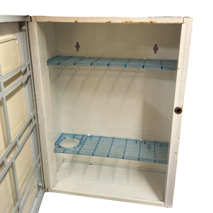 close up of a vintage metal bathroom cabinet inside view on a white background