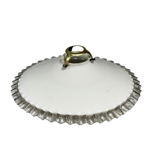 White round vintage glass lampshade with a frilled clear edge and a brass collar on a white background