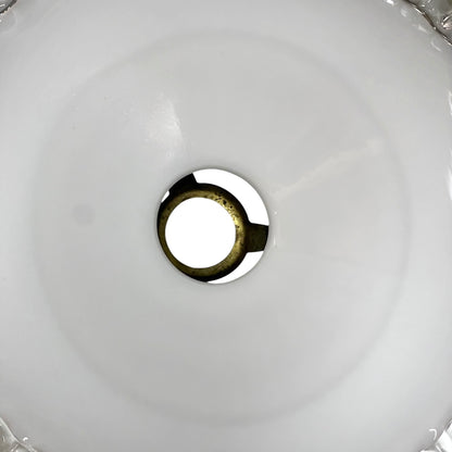 Close-up of a round metallic object on a white background