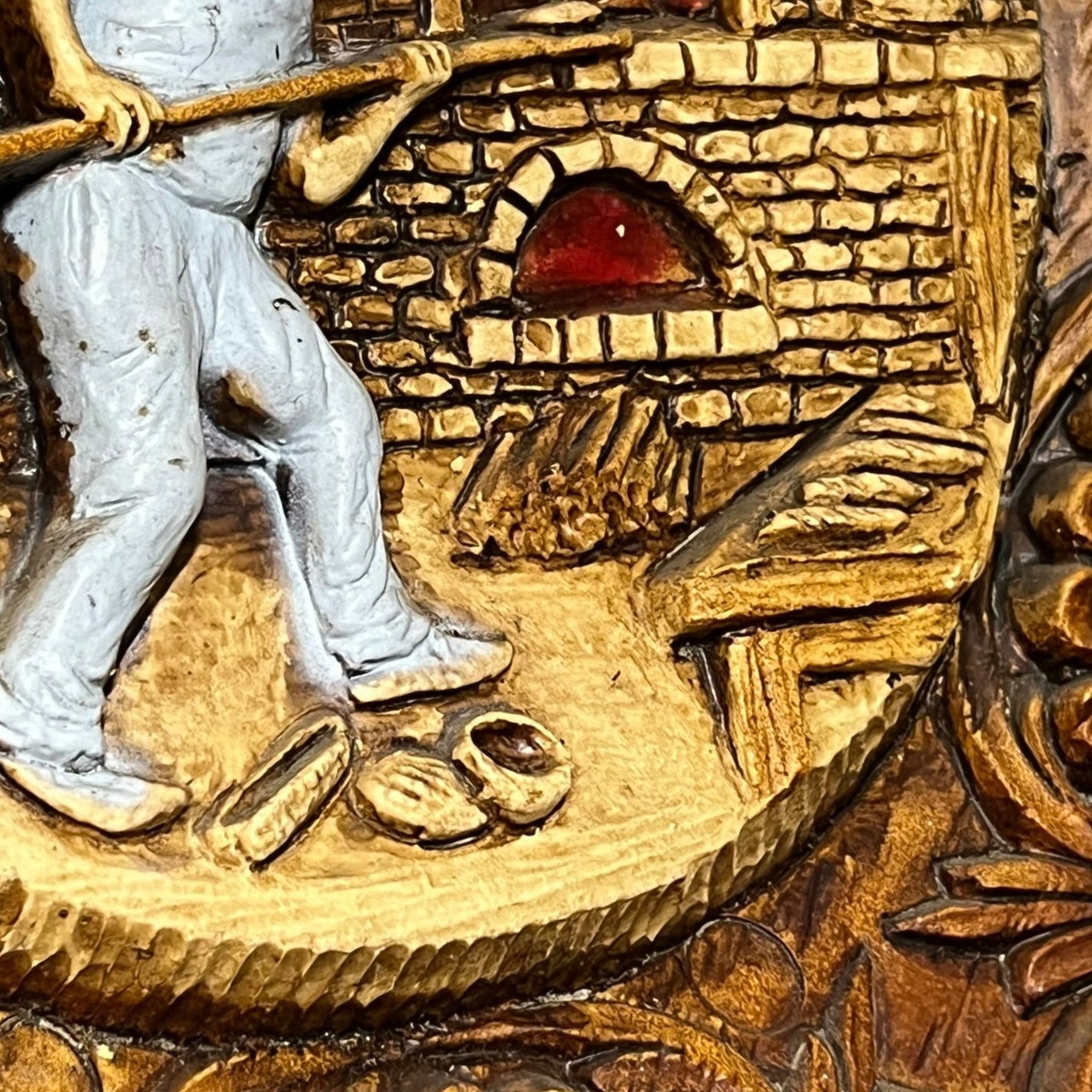 Close up of a raised 3d wood resin wall plaque of a French baker on a white background