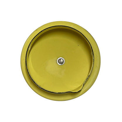 A round yellow metal teapot lid with a central screw and a black inner rim, shown against a plain white background.