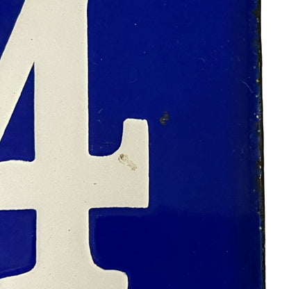 Close-up of a blue and white logo with a number '4' on a dark background