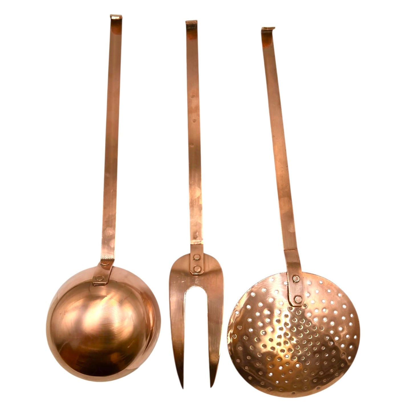 Set of three copper kitchen utensils on a white background