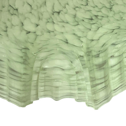 A close-up of a pale sage green glass lampshade pattern, shown against a white background.