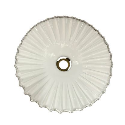 Close up of a White scalloped-edge glass lampshade with brass fitting on a white background, for a period living room styling or vintage home decor 