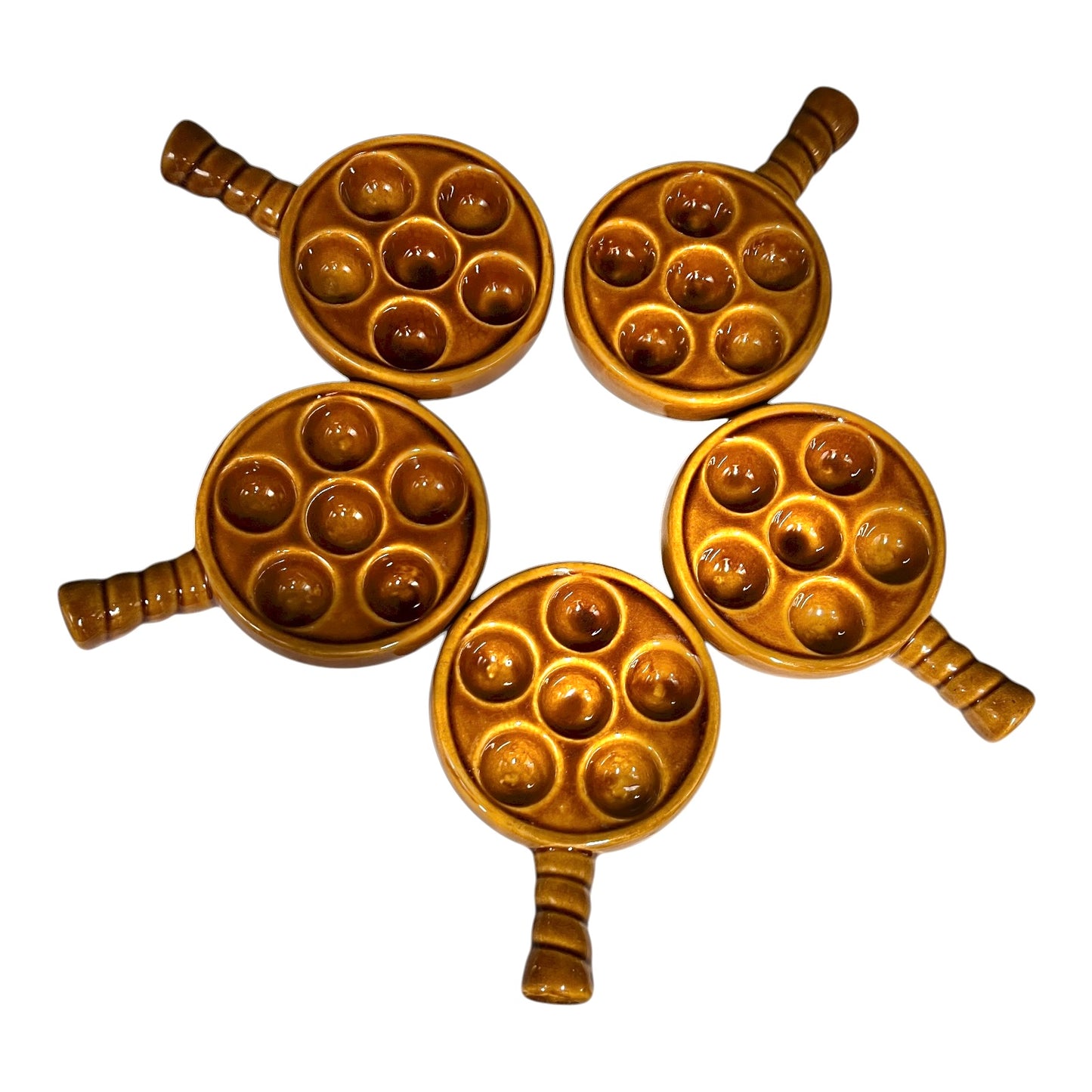 set of 5 amber brown coloured 6 hole snail plates on a white background 