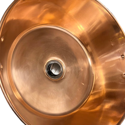 French copper bowl upcycled into a copper sink with iron handles and a chrome pop up waste on a white background