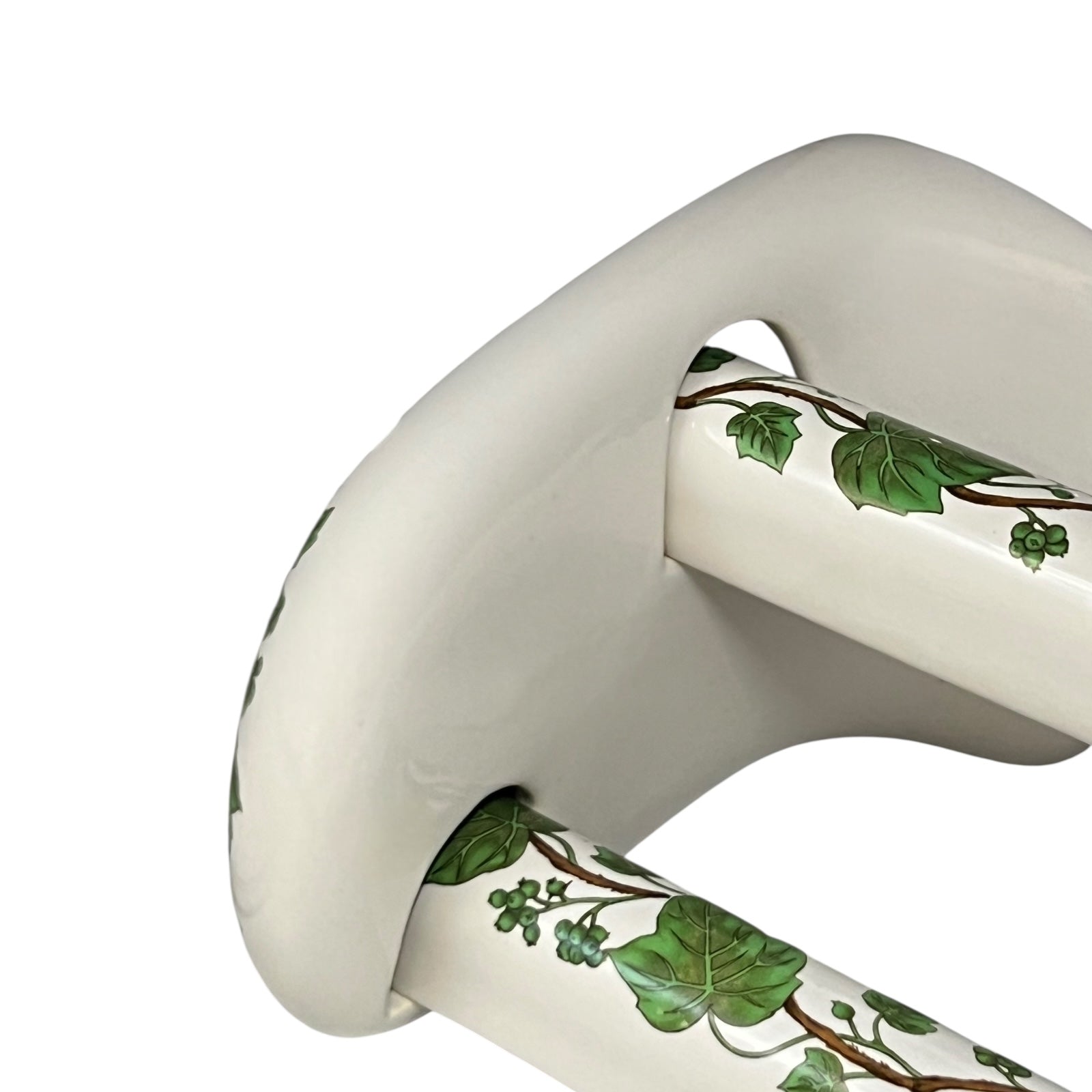 White and green leaf patterned towel rails and brackets on a white background