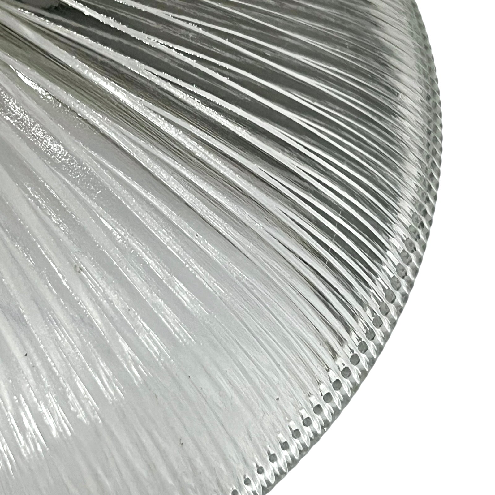 Close-up of a ribbed glass lampshade with reflective surface