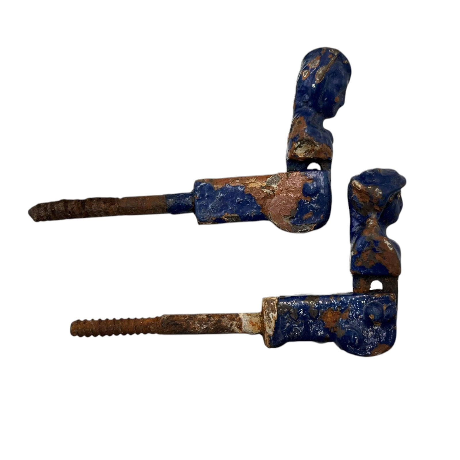 Pair of French cast iron shutter dogs painted blue with signs and age and wear on a white background