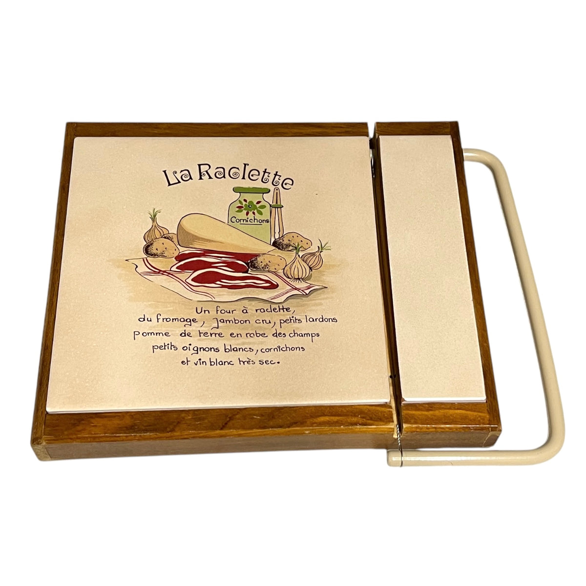 Vintage French La Raclette cheese board with cream ceramic tiled top, wooden base and integral cheese wire, styled on a light white background 