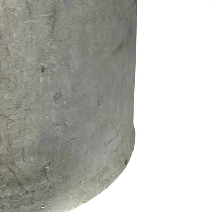 Close up of a vintage metal milk churn on a white background