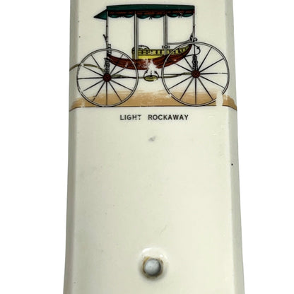 Close up of fingerplate with vintage car illustrations on a white background