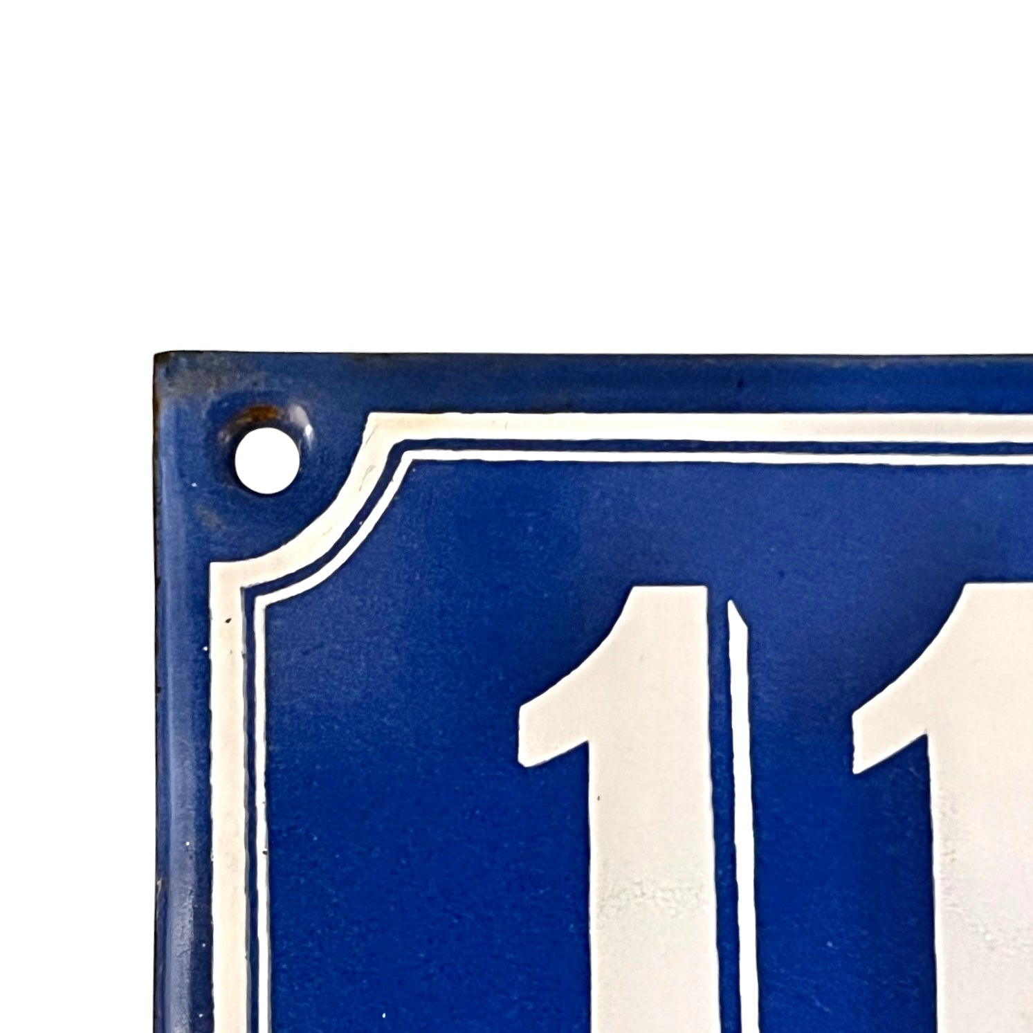 Blue and white number 110 sign on a white background