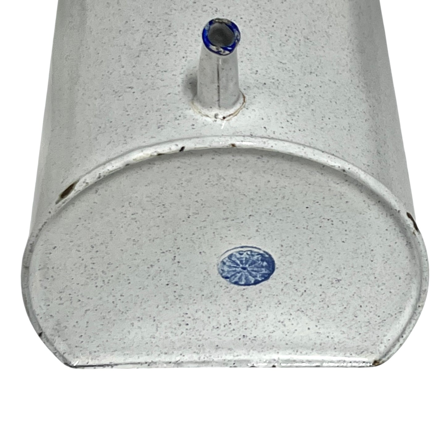 Close-up of the base of an enamel planter with speckled glaze and blue rim and a makers stamp on a white background