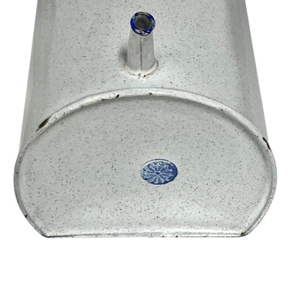 Close-up of the base of an enamel planter with speckled glaze and blue rim and a makers stamp on a white background