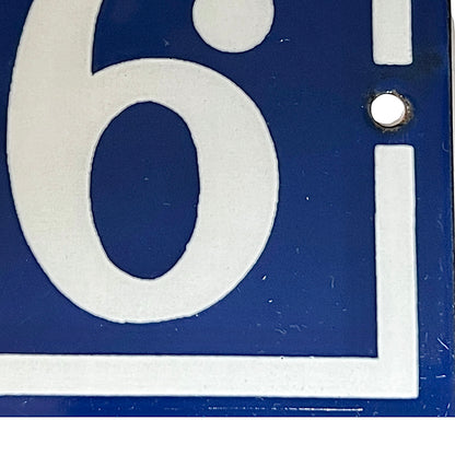 Close up of a French blue and white enamel door number - 76