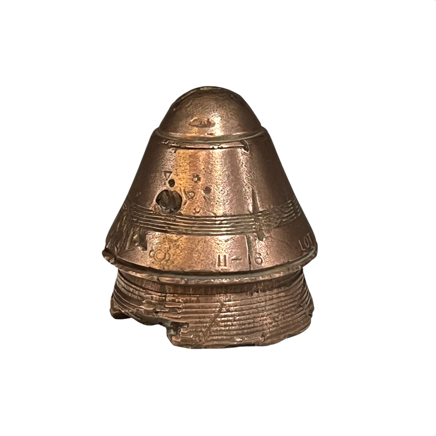 WW1 brass fuse paperweight on a white background 