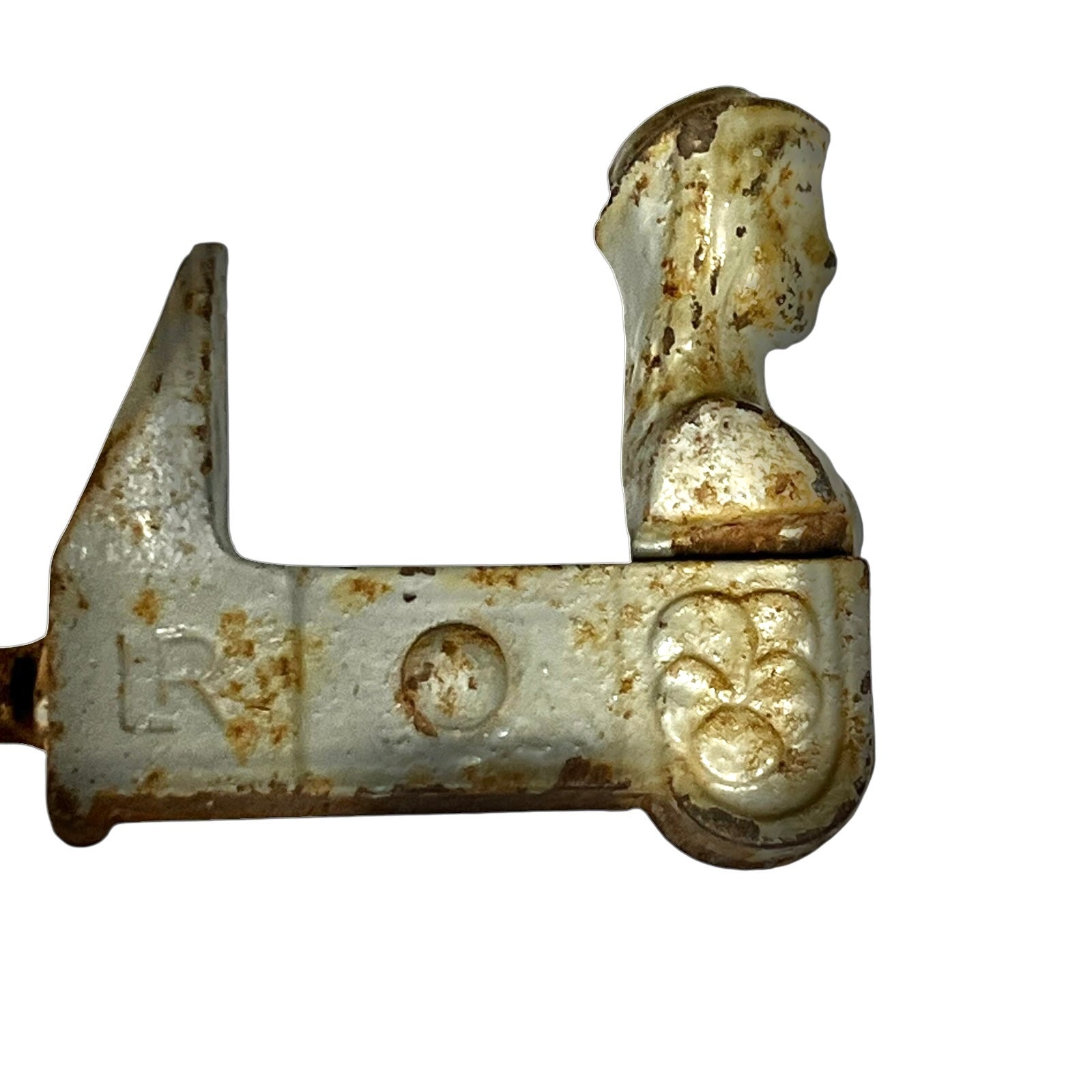 A vintage cast iron shutter dog catch with a weathered silver and rusted brown patina, featuring a decorative floral relief on the right side and a partially visible letter 'R' on the left, shown against a plain white background.