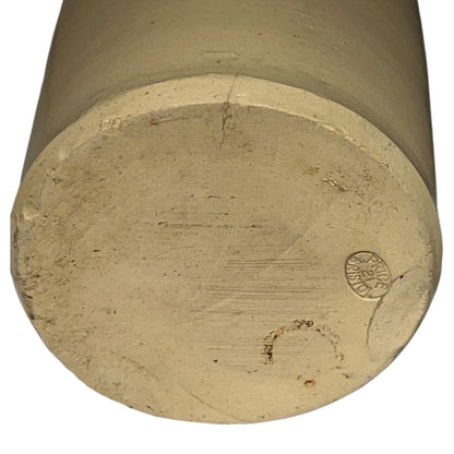Close up of a beige cylindrical WW1 jar on a white background