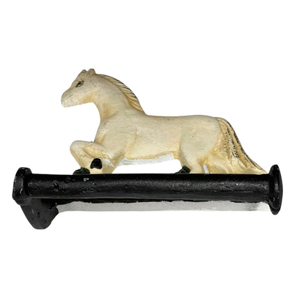 Close up of white horse toilet paper holder against a white background