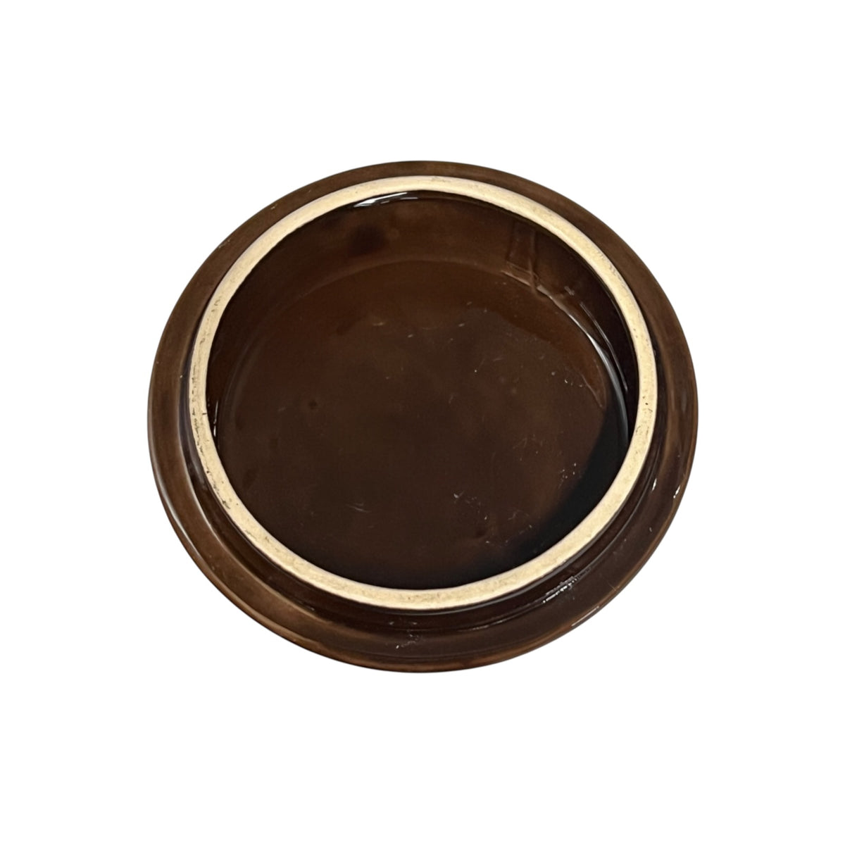 A round, dark brown ceramic jar lid with a glossy finish and a light beige inner rim, shown from a top-down perspective on a white background.