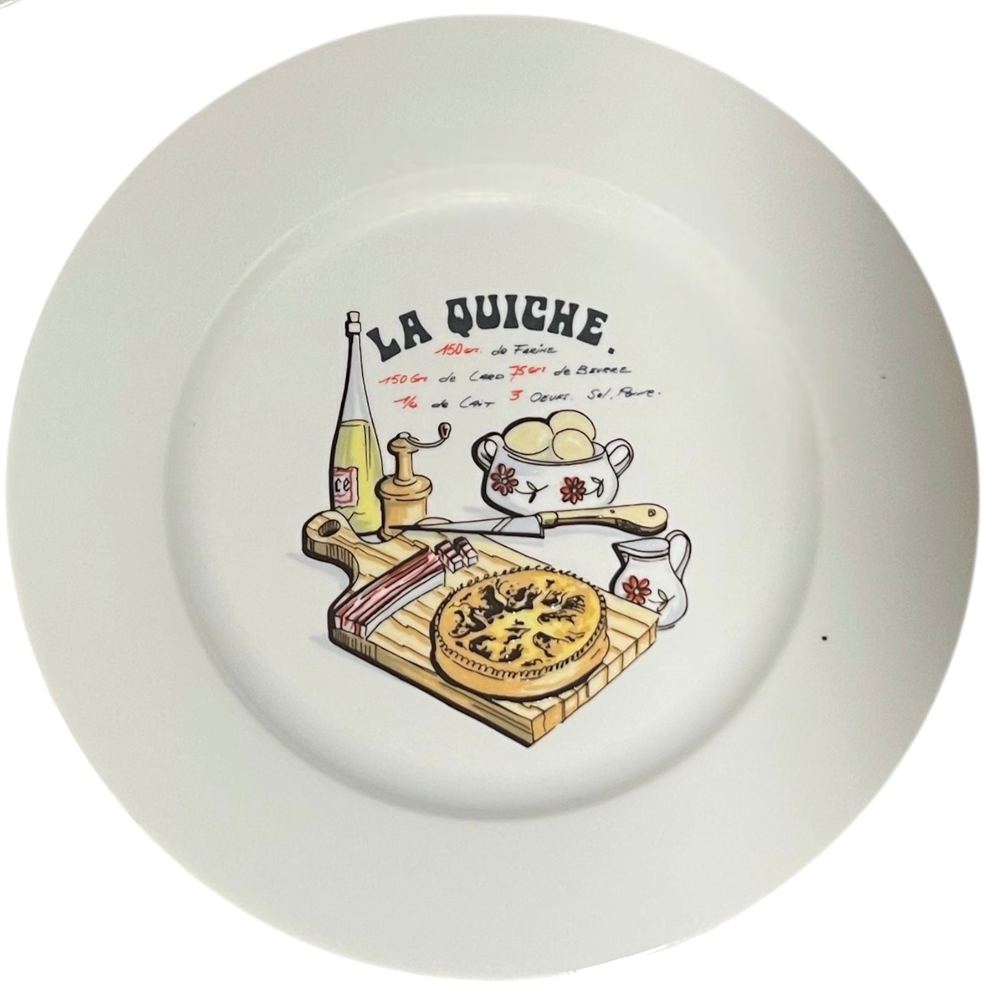 White plate with a decorative illustration of a quiche and kitchen items, featuring the text 'La Quiche'.