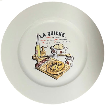 White plate with a decorative illustration of a quiche and kitchen items, featuring the text 'La Quiche'.