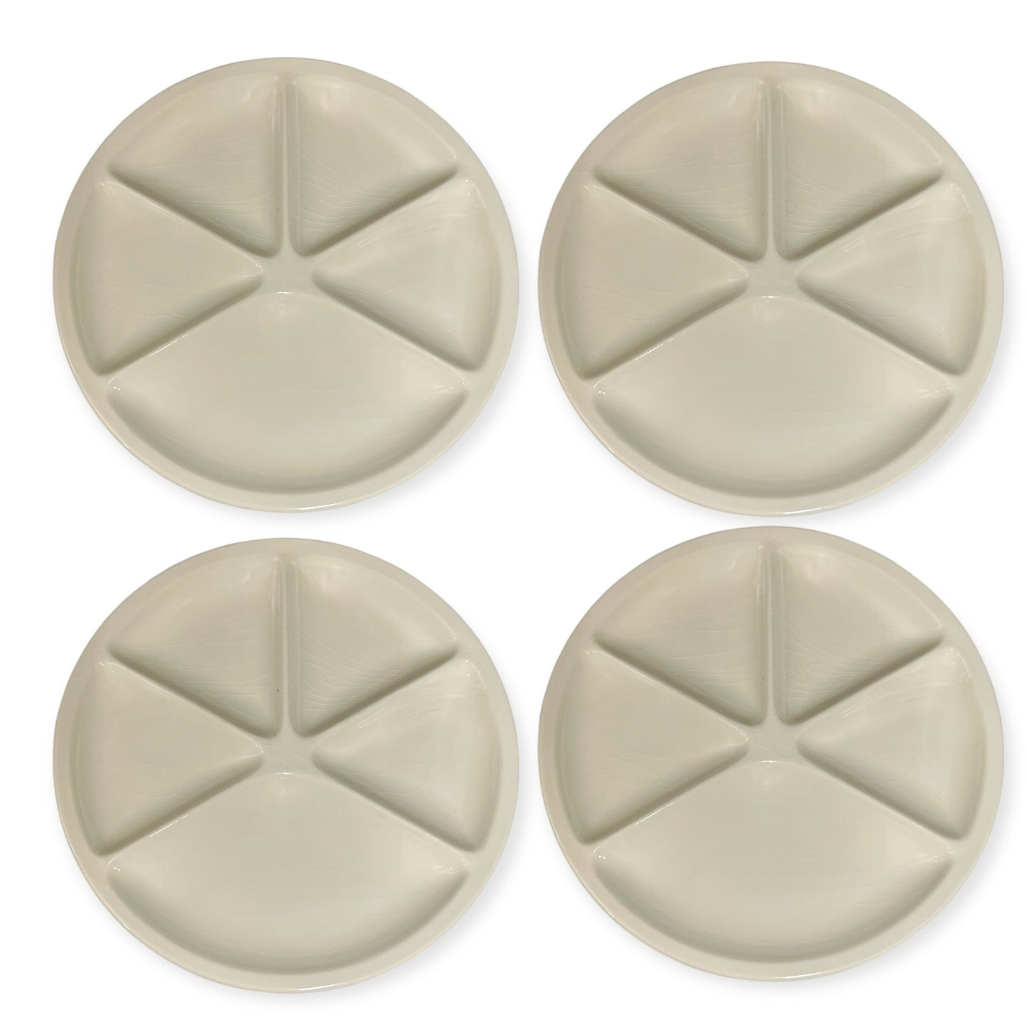 Set of beige Le Creuset divided fondue plates  on a white background