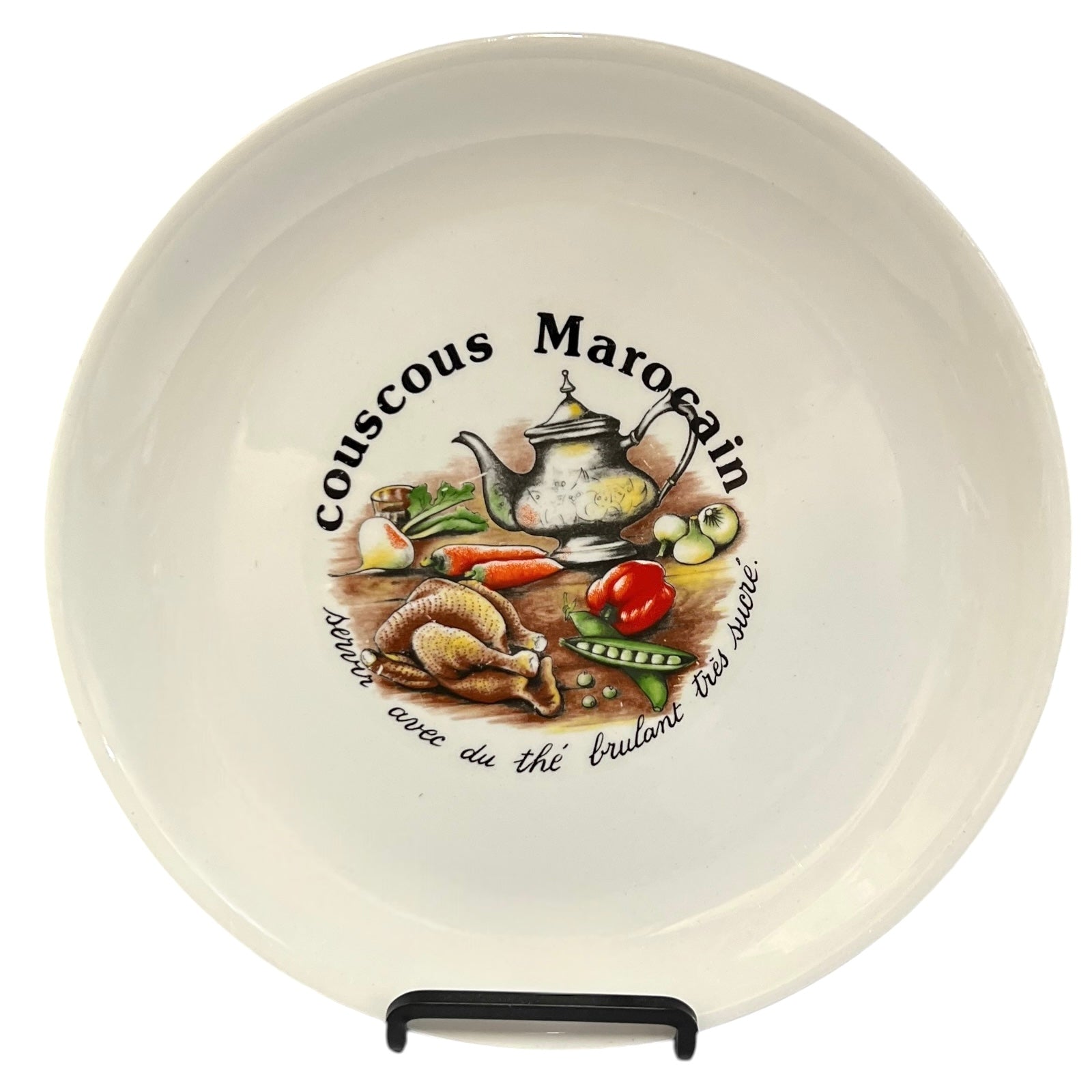 Ceramic plate with couscous Marocain design featuring a teapot and vegetables on a white background.