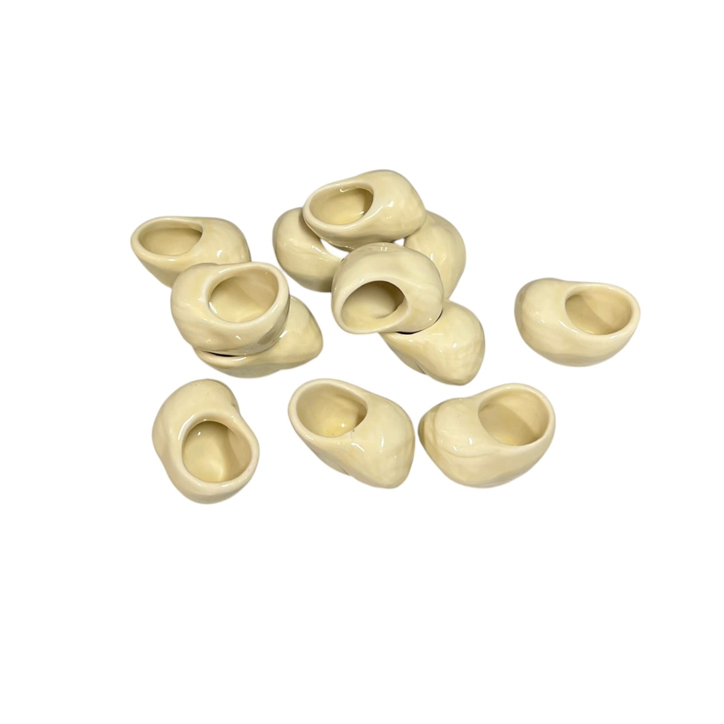 Set of 12 ceramic French escargot cups shaped like snails ideal for a restaurant or a keen French cook, set on a white background