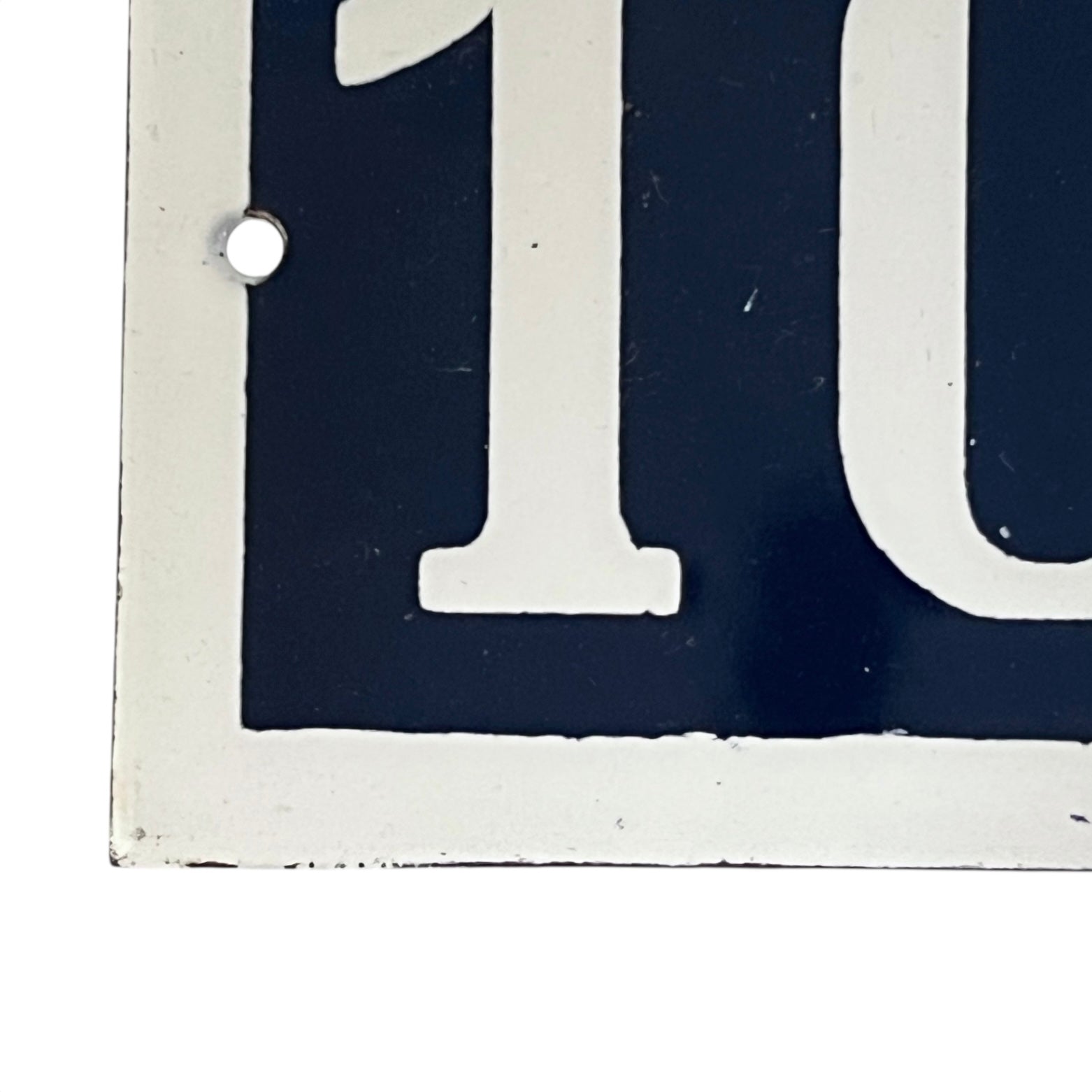 Close-up of a vintage-style sign with the number on a white background