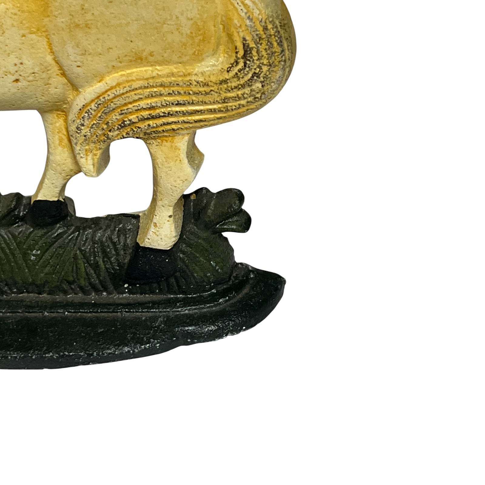Close-up of a decorative figurine showing the lower body of a horse standing on a dark textured base, photographed against a plain white background.